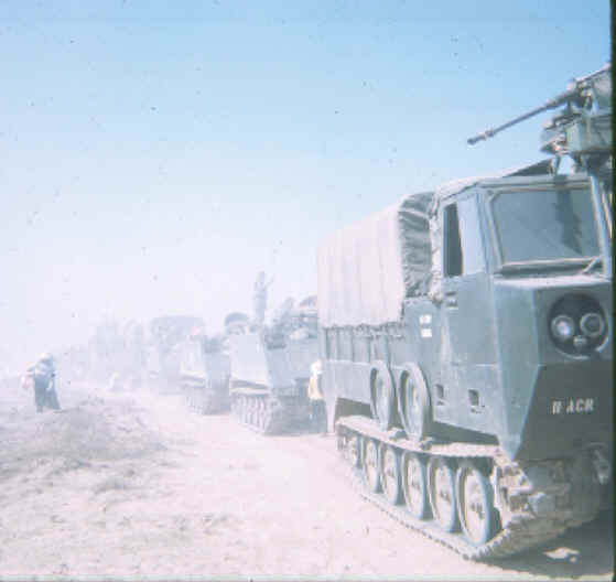 Convoy stops at FSB Holiday Inn as dust hangs in calm hot air